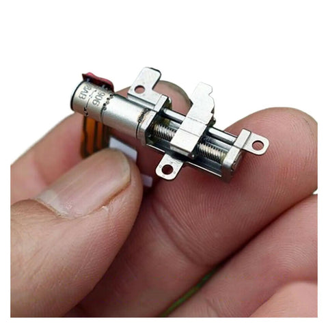 Close-up of 5mm Gearbox Stepper Motor, 8mm Stroke Linear Actuator for phone camera rigs, held between fingers for size reference.