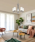 Five Light Modern Chandelier in Brushed Nickel Finish With Clear Hammered Glass Pendants hanging in living room setting.
