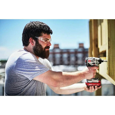 Man using 20V Max Impact Driver With Battery And Charger Included One Quarter Inch Chuck 2700 RPM Brushless Motor on wood