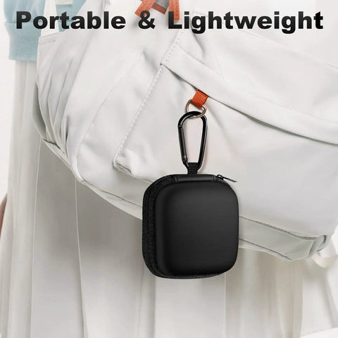 Black Carry Anywhere EVA Earbud Case with Carabiner attached to a white bag, portable for wired and wireless earphones