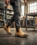 Mens 6 Inch Steel Toe Slip On Work Boots Chelsea Waterproof Safety Footwear Heavy Duty in a workshop setting.