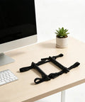 Built Tough Under Desk PC Mount With Quick Lock Straps on wooden desk beside computer and plant, designed for workspace organization.