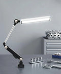 Heavy Duty 110V 16W LED Machine Work Light with adjustable bracket illuminating tools on a workshop table.