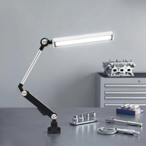 Heavy Duty 110V 16W LED Machine Work Light with adjustable bracket illuminating tools on a workshop table.