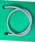 Garment Steamer Hose With High Temperature Resistant Steam Tube coiled on green surface.