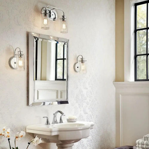 Bathroom interior with Braelyn 1 Light Wall Sconce With Clear Seeded Glass In Classic Pewter beside a mirror