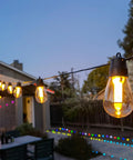 Outdoor String Lights With Dimmer And App Control 100 Ft Led Patio Lights Waterproof Commercial Grade Timer glowing in backyard