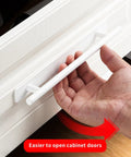 Hand demonstrating use of Two Pack Stick On Cabinet Handles White Self Adhesive Drawer Pulls Closet Doors For Kitchen Sliding Glass And Shower Doors