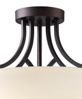 Close-up of Three Light Semi-Flush Ceiling Mount In Oil Rubbed Bronze With Flat Opal Glass Shade For Kitchen Or Dining Room, featuring ornate metal detail.