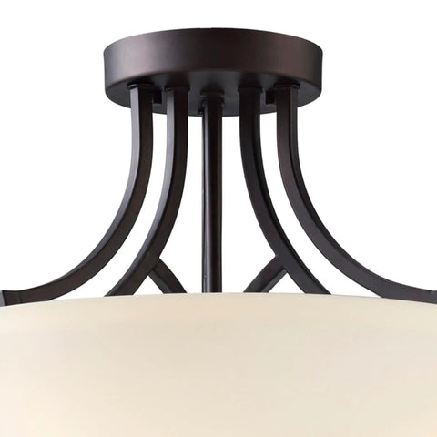 Close-up of Three Light Semi-Flush Ceiling Mount In Oil Rubbed Bronze With Flat Opal Glass Shade For Kitchen Or Dining Room, featuring ornate metal detail.