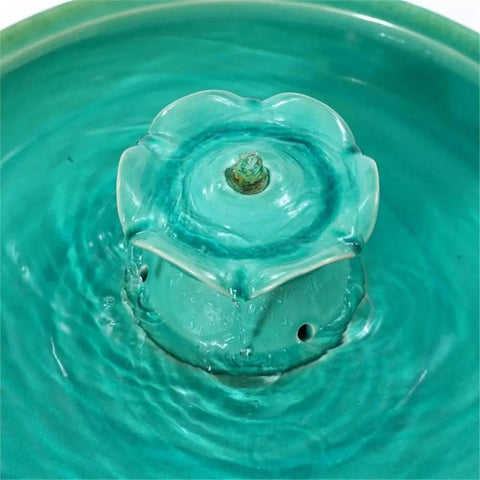Close-up of 22 Inch Ceramic Bird Bath Fountain With Lotus Design in glazed aqua green, showing lotus detail for garden decor.