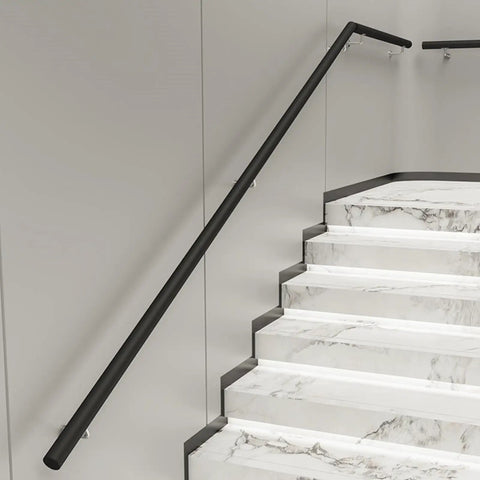 Knockout Modern Black Handrail Kit With Hella Non Slip Grip mounted on marble stairs, 0.8 inch grip diameter.