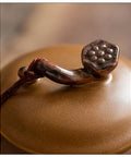 A close-up of the Ruyi lid handle on the Solid Glazed Ceramic Tea Canister with intricate detailing for securing contents.