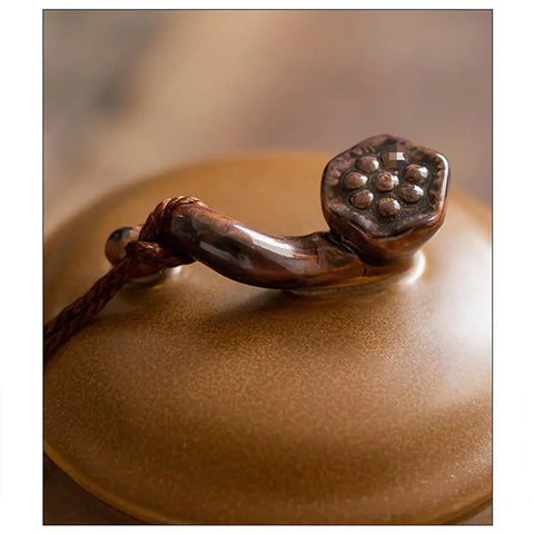 A close-up of the Ruyi lid handle on the Solid Glazed Ceramic Tea Canister with intricate detailing for securing contents.
