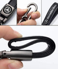 Close-up of Mercedes Benz Tire Valve Caps And Leather Keychain Set showing black leather strap and metallic clasp.