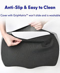 Hands opening cover of ergonomic under desk foot rest with Massage Ridge design and memory foam pillow, showing anti-slip feature.