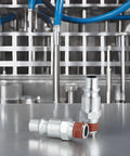 Two 3/8 inch steel high-flow air hose fittings with red thread sealant and M-type plug on stainless surface.