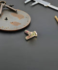 Secure Your Wheels With These 2 Pack M10 Wheel Lug Bolts Metal Studs close-up on a workbench with tools, highlighting their finish.