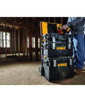 Person using Rugged ToughSystem Tool Box With Pull Back Lid For Maximum Storage Non Detachable Lid Wide Grip Handle