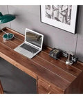 Ergonomic Adjustable Standing Desk Featuring Rich Walnut Desktop Four Deep Storage Drawers Integrated Monitor Stand view from above with laptop and lamp