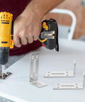 Heavy Duty Stainless Steel Adjustable L Shaped Brackets With Slotted Holes For Chairs And Tables, person using drill on bracket