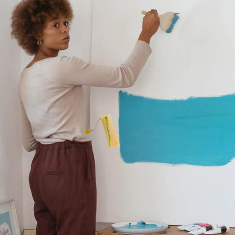 Person using a Heavy Duty Cotton Thread Paint Roller With Zero Hassle Grip And Smooth Roll Action on a wall.