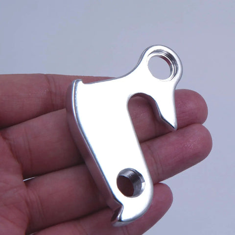 Hand holding Derailleur Hanger 43 GH002 Replacement For Nishiki Back Roads Colorado Raleigh F500 CNC Alloy Silver Dropout