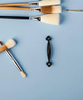 Vintage Zinc Alloy Cabinet Door Handles 10 Pack Black Curved Gate Pulls Rustic Furniture Hardware on blue background.