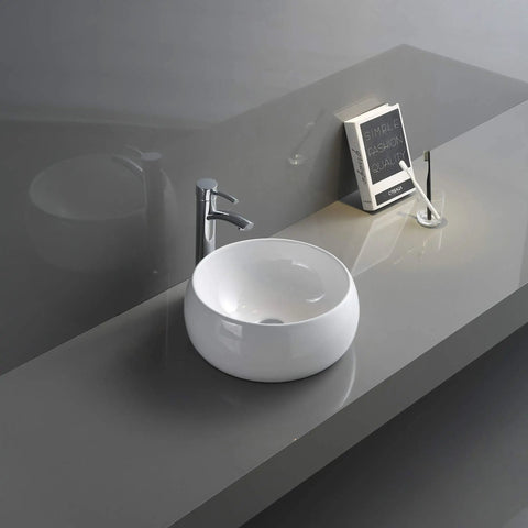 Top Mount 12 Inch Round White Vessel Sink For Bathroom Vanity, Durable Solid Porcelain Ceramic Construction, Above Counter Installation, No Mounting Ring Needed, Glazed Non-Porous Finish For Easy Cleaning on a gray vanity