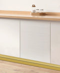 Top Tier Matte Gold L Shaped Corner Guards Peel And Stick Molding Trim For Furniture Edge Bumper Table Door Frame Protector No Sweat Diy Installation Smooth Vibe Check For Any Crib Upgraded Room Makeover At Sixteen Feet Long on a white cabinet.