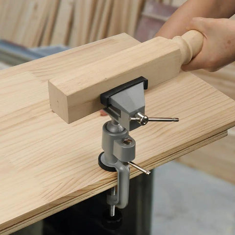 Universal Table Vise 3 Inch With 360 Degree Swivel Base in use on a workbench, holding a wooden piece securely for woodworking.