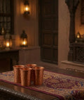 Four hammered copper glasses from Copper Hammered Water Dispenser With Tap And Stand, Four Copper Glasses Included, 6.5 Liter Capacity
