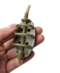 Hand holding inline method feeder from Inline Method Feeder Set For Carp Fishing With Four Inline Feeders And One Rubber Mold.