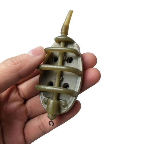 Hand holding inline method feeder from Inline Method Feeder Set For Carp Fishing With Four Inline Feeders And One Rubber Mold.