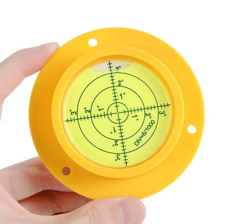 Hand holding 90mm Green Bullseye Bubble Level With Mounting Holes, Heavy Duty Pro Grade Spirit Level for RVs and Construction