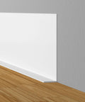 5 Inch Peel And Stick Vinyl Baseboard Trim 20 Feet Flexible Cove Baseboard Molding installed between wall and wooden floor