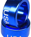 Blue anodized billet aluminum steering wheel column sleeve, intermediate shaft bushing with USA engraving, side view.
