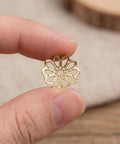 Natural Metal Bead Caps And Flower Spacer Pendants For DIY Jewelry Making shown in hand close-up