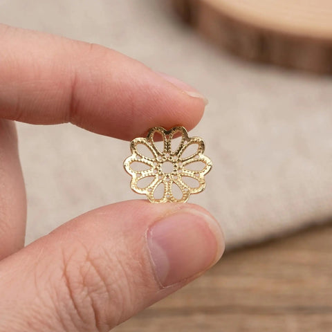 Natural Metal Bead Caps And Flower Spacer Pendants For DIY Jewelry Making shown in hand close-up
