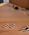 50 Pcs Premium M5 Cross Dowel Nuts Silver Carbon Steel Barrel Nut Connector Hardware on wooden table with screws and connectors
