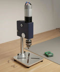 Bothyi Miniature Desktop Drill Press Workbench Tool Vertical Precision Boring compact footprint with stable metal housing on workbench.