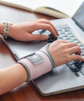 Person typing on laptop wearing Two Pack Copper Wrist Braces For Carpal Tunnel Pain Relief Arthritis And Tendonitis Adjustable All Day.