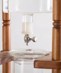 Close-up of the Badass Cold Brew Drip Tower Holds 25 Cups With Solid Wood Base, Slow Drip Ice Coffee Maker faucet.