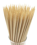 The Real Deal Natural Bamboo Skewers For Backyard Barbecue And Roasting Marshmallows 4mm Thick Solid Round Shape 100 Pack in a clear glass.