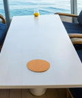Round Cork Coasters And Pot Saucers 2 Pack For Drinks And Plants, Absorbent Natural Cork Pads With No Mess No Fuss, Scratch Prevention, Reusable And Easy Maintenance For Patio And Diy Crafts. Round cork coaster on white table near drink