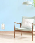 Living room with PlugIns Air Freshener Starter Kit With Two Fragrance Oil Warmers And Six Refills In Clean Linen Scent on wall outlet