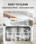Top Shelf Rechargeable Two Speed Milk Frother With Dual Spring Stainless Whisk being rinsed under water, showcasing its easy cleaning.