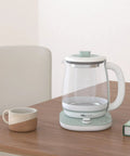 All In One Health Pot Electric Kettle With Infuser, Glass Kettle And Stew Pot, 16 Menu Boil Functions, 1.8L Capacity, Green on table