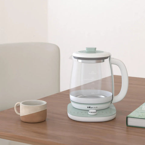 All In One Health Pot Electric Kettle With Infuser, Glass Kettle And Stew Pot, 16 Menu Boil Functions, 1.8L Capacity, Green on table