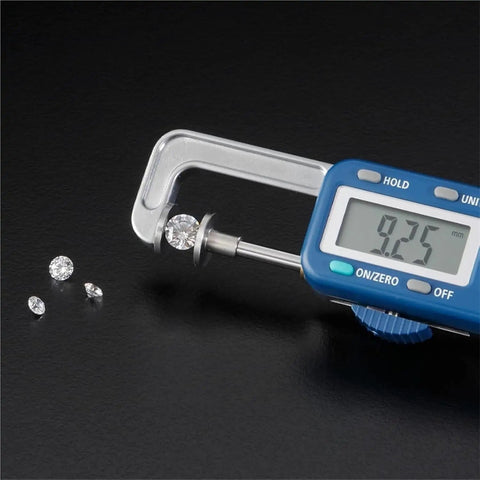 Jewelry-Making Digital Caliper,25mm Range,0.01mm Precision Thickness Gauge measuring a diamond at 9.25mm with smaller diamonds beside.